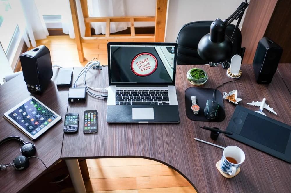 A desktop with mobile Devices and a Laptop Computer on it