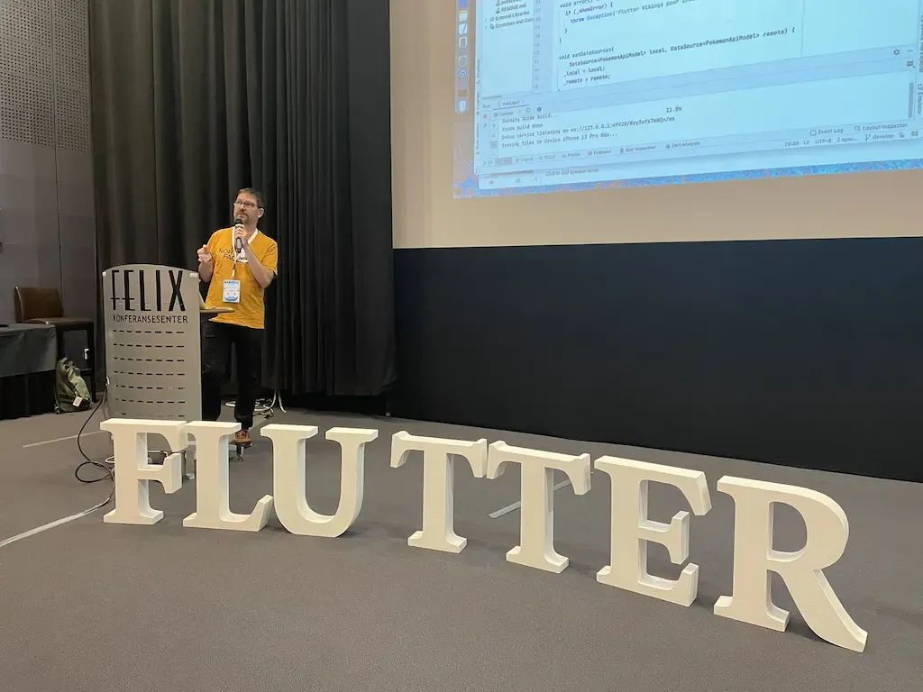 Alessio Salvadorini on a Stage talking about Flutter architecture